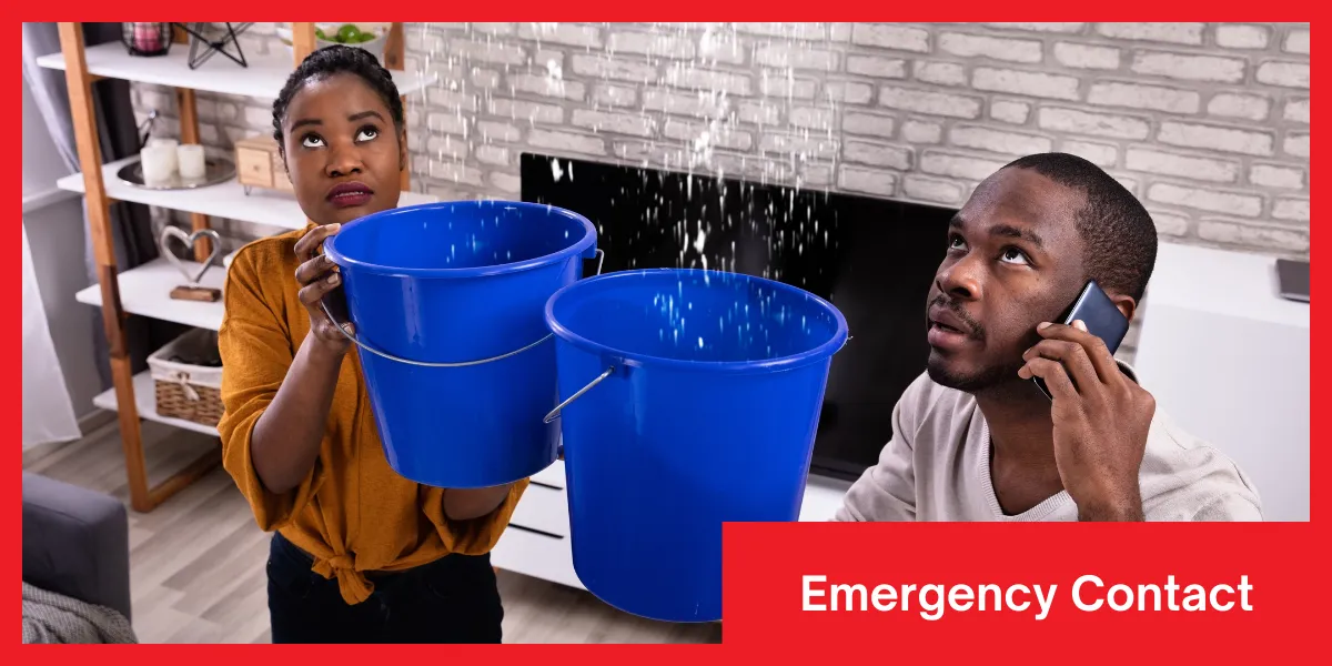 Emergency Contact Two people in a flooded room holding buckets to catch water while the other is calling for emergency help.